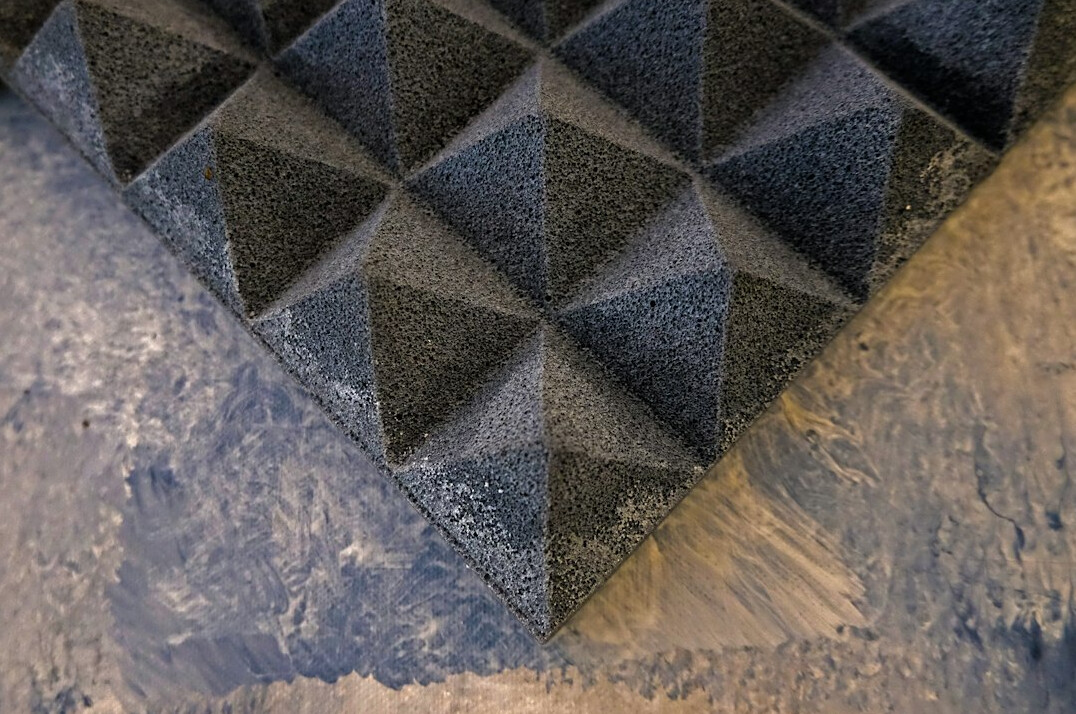 Acoustic treated studio with foam panels and boom microphone